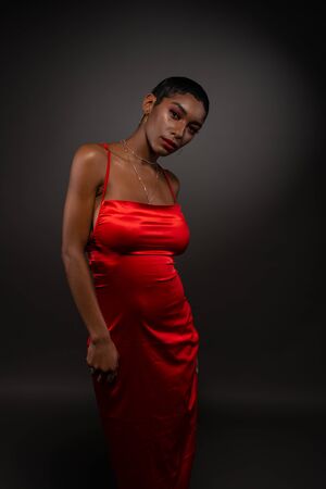 Slender young African American woman in a tight red dressの写真素材