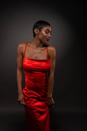 Slender young African American woman in a tight red dressの写真素材