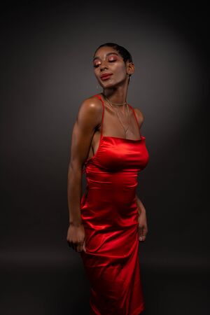 Slender young African American woman in a tight red dressの写真素材