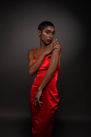 Slender young African American woman in a tight red dressの写真素材
