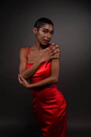 Slender young African American woman in a tight red dressの写真素材