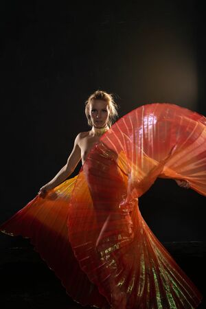 Beautiful slender blonde woman waving bright translucent wingsの写真素材