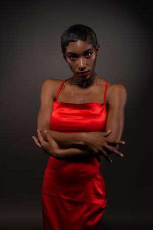 Slender young African American woman in a tight red dressの写真素材