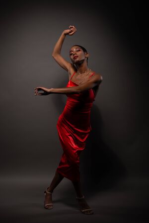 Slender young African American woman in a tight red dressの写真素材
