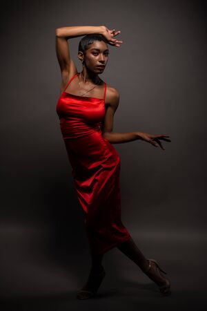 Slender young African American woman in a tight red dressの写真素材