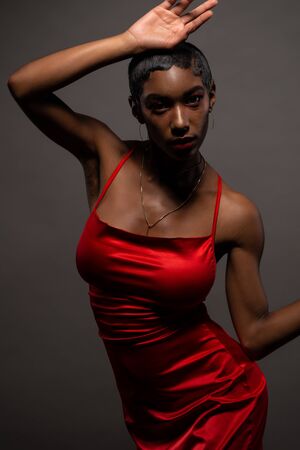 Slender young African American woman in a tight red dressの写真素材