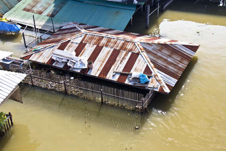 Bangkok Thailand October 2011: Flood in to Pak kret market, Nonthaburi province, the water from Chao praya river flow into house almost cover the roof.のeditorial素材
