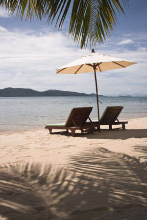 The beach deck-chair and umbrellasの写真素材