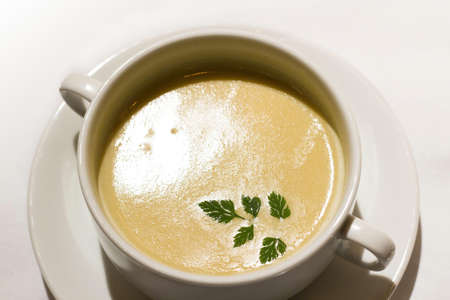 mushroom soup with green leaf on white cupの写真素材