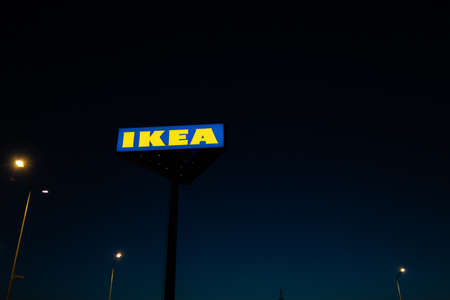 RIGA, LATVIA - APRIL 3, 2019: IKEA brand sign during dark evening and wind - Blue sky in the...
