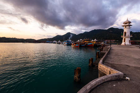 Vivid sunset with a view on a popular fishermens village Bang Bao at Ko Chang island in Thailandの写真素材