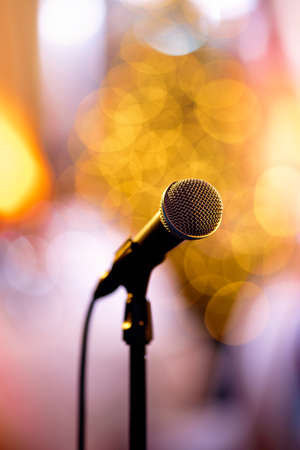 Isolated bokeh microphone on a concert stage with artists redy to perform in the backstageの写真素材