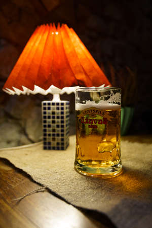 SABILE, LATVIA - APRIL 21, 2019: Glass of Uzavas light beer at a Krogs restaurantのeditorial素材