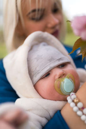 Young mother woman enjoying free time with her baby boy child - Caucasian white child with a parents...