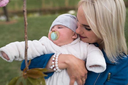 Young mother woman enjoying free time with her baby boy child - Caucasian white child with a parents...