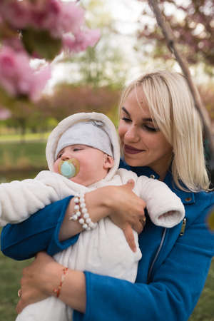 Young mother woman enjoying free time with her baby boy child - Caucasian white child with a parents...
