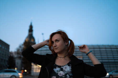 Redhead woman portrait in front of a glass building - Traveler and explorer