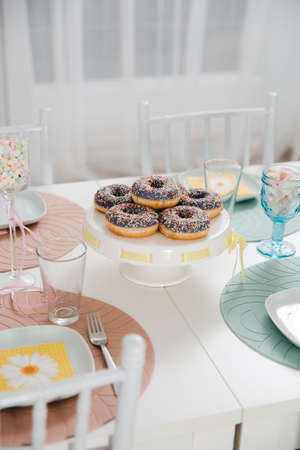 Food served on table in a white hall during a children Birthday party decoration in Eastern European Baltic Riga Latvia - Mild Biege, creme, pink colors - Canape, snacks and light drinksの写真素材