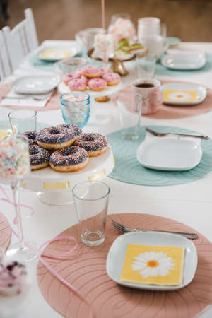 Food served on table in a white hall during a children Birthday party decoration in Eastern European Baltic Riga Latvia - Mild Biege, creme, pink colors - Canape, snacks and light drinksの写真素材