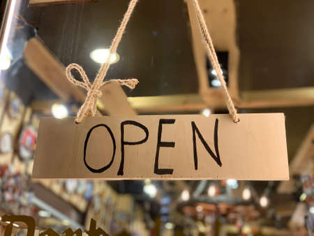 Open wooden sign at the shop window of a traditional Chtistmas gift shop in Eastern European Baltic Riga Latviaの写真素材