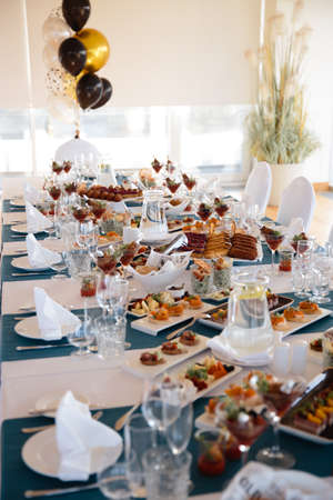 Food served on table in a white hall during a Birthday party in Eastern European Baltic Riga Latvia - Blue and teal colors - Canape, snacks and light drinksの写真素材