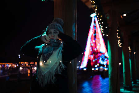 Making faces - Young attractive redhead girl hanging out in amusement theme park with bright vivid...