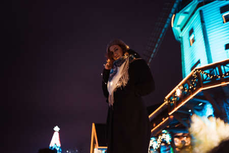 Portrait - Young attractive redhead girl hanging out in amusement theme park with bright vivid...