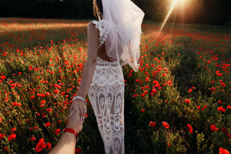 followmeto with a bride in an afternoon red poppy field in Latviaの写真素材