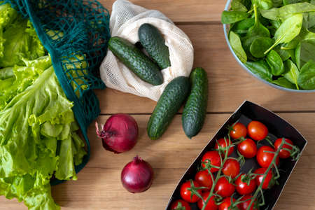 Flatlay of salad, onion, cucumber, cherry tomatoes and basil