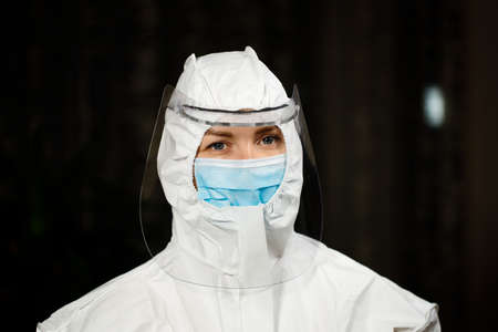 Healthcare doctor in protective medical suit with mask and shieldの写真素材