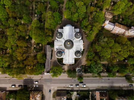 Top view of white orthodox church among green treesの写真素材