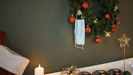 Surgical face mask hanging on christmas wreath