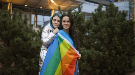 Two cute bisexual women hugging in public