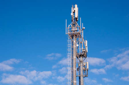 Telecommunication Tower With Blue Sky And White Clouds Background. Antenna On Blue Sky.の写真素材