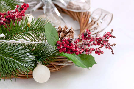 Christmas Decorative Wreath Decorated with Berries, Christmas Tree Branches, Pinecone and Christmas Ballの写真素材