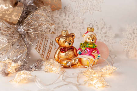 Christmas background with golden stars. New Year's decor. Christmas ball and golden bear. White snowflakes.の写真素材
