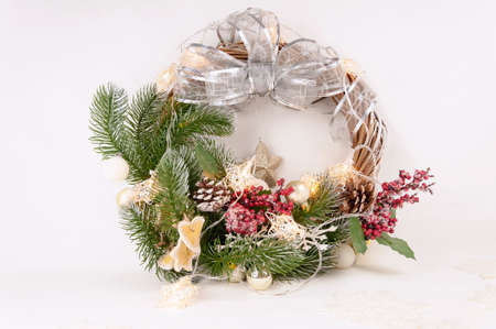 Christmas Decorative Wreath Decorated with Berries, Christmas Tree Branches, Pinecone and Christmas Ball, luminous starsの写真素材
