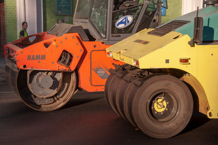 Two modern heavy asphalt roller Ammann that stack and press hot asphalt. Yellow and red road repair machine. Russia Krasnodar 9 November 2020.のeditorial素材