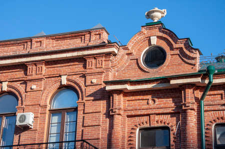 An old red brick house with a round windowの写真素材
