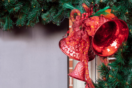 Christmas decoration red bells on artificial fir branchの写真素材