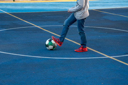 Krasnodar, Russia - December 4 2020: boy with a ball on the mini-football field foot on ballのeditorial素材