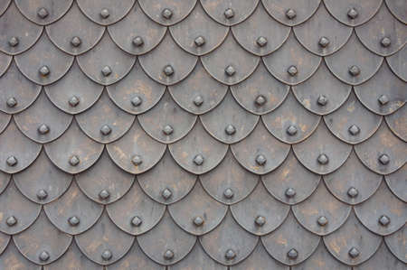 Medieval rusty metal grey scales armor background. Template for border, frame design.の写真素材