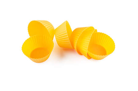 Orange yellow silicone form moulds for cooking muffin and cupcake isolated on white.の写真素材