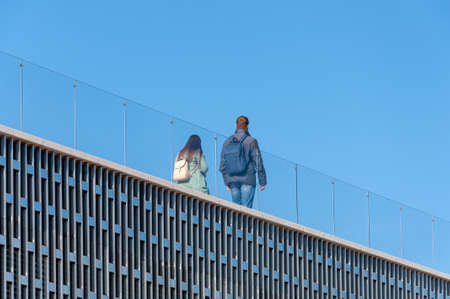 Happy Couple Walking On The Bridge In The Evening In The Parkの写真素材