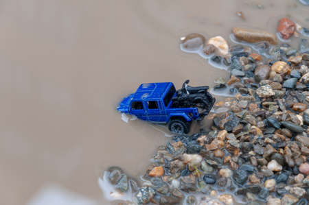 Car crosses river. Car submerged in flood water. Flood Insurance concept image. Driving through deep waterの写真素材