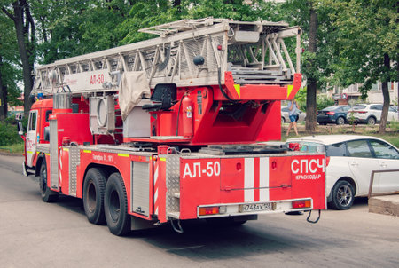 Krasnodar, Russia - July 27 2021: Fire trucks ladder truck during a rescue mission. Big fire truck.