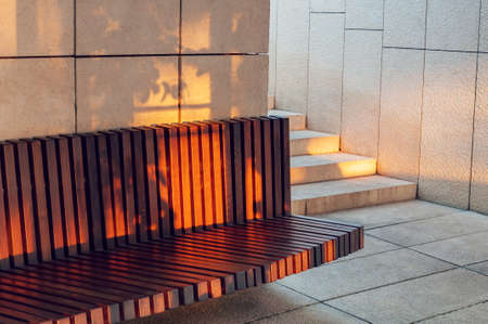 Modern brown wooden bench outdoor. City improvement, urban planning, public spacesの写真素材