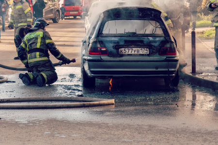 Krasnodar, Russia - November 24 2021: Firefighters attack a propane fire. Fireman Putting Out Fire. Firemen extinguishing a car fireのeditorial素材