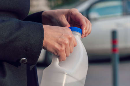 Woman clasping cap of a plastic bottle. Sustainable, Eco friendly, Refuse one-time use plastic, Zero waste.の写真素材