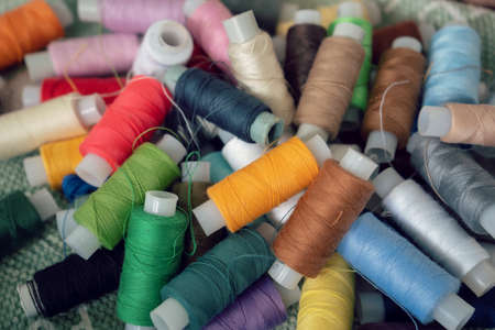 Sewing threads as a multicolored background. High angle view of colored threads for tailor jobの写真素材